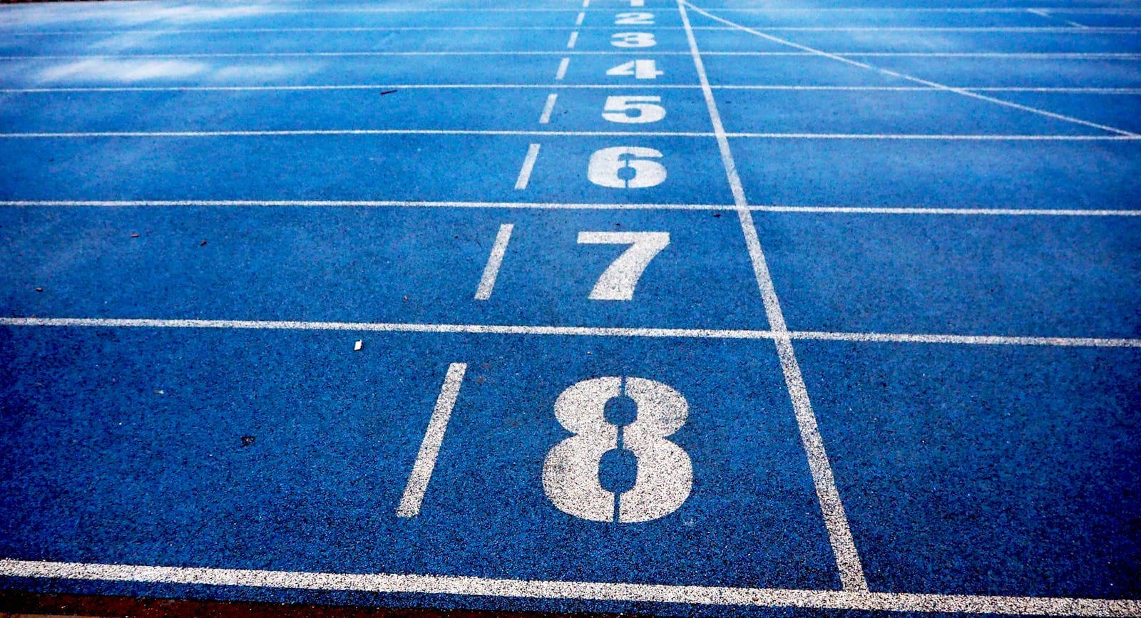 Empty numbered lanes on a blue running track